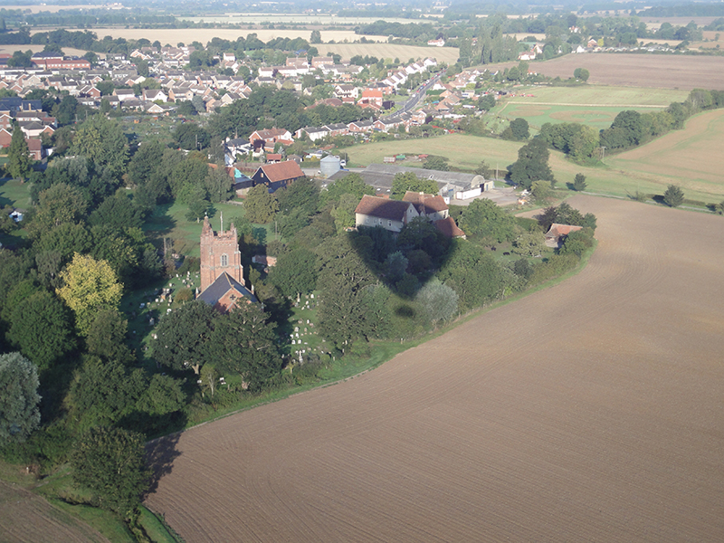 Black Notley is one of the three &ldquo;Notleys&rdquo; in Essex near Chelmsford. This is a great aerial picture on a balloon ride floating close to the spire of the local church St Peter and St Paul Black Notley just before landing at the nearby farm in a cut grass field