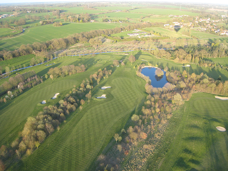 You can see that the small Essex village of Stisted in the background of this aerial picture is only a fraction of the size of the golf course when viewed from a balloon basket. Although not always at this location Braintree Golf Club has been in existence since 1891 and is the third oldest course in the county of Essex. It moved from its nine hole course at Braintree to the current location in 1971 when the Braintree by pass was built. Golfers often wave to low flying balloons, particularly on morning flights when we are both up soon after dawn!&nbsp;